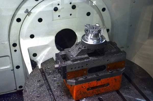 CNC milling machine during operation. The process of drilling holes in the metal auto parts. View through safety glass, small roughness sharpness, possible granularity