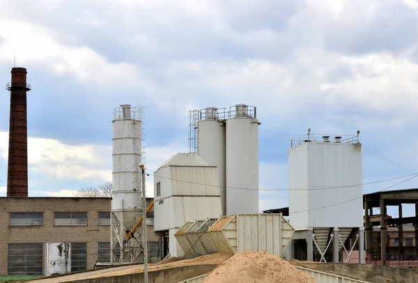 Concrete Batching Plant. Industrial producing cement for construction. Cement manufacturers mine and process raw materials and put them through a chemical reaction process to create cement.