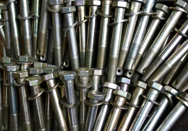 Background of screw bolts, Internal screw, nuts, many screws.  Factory equipment and Industrial concept. Small roughness sharpness, possible granularity, blurred focus  - Image