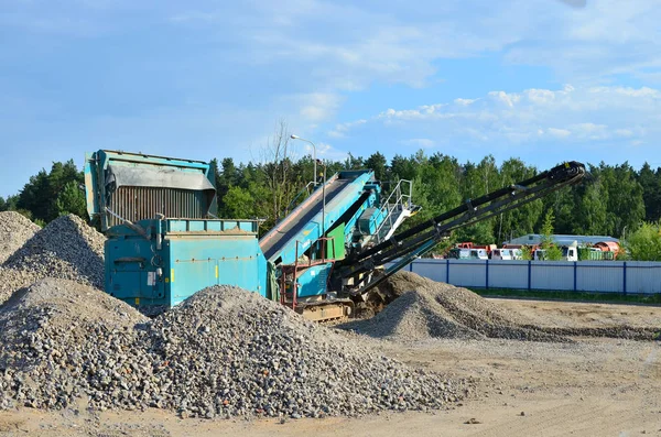 Concrete recycling shredding machine. Modern building techniques concrete processing, crusher and processing asphalt concrete, stones and rebar shredder. Reinforced concrete mobile shredder - Image