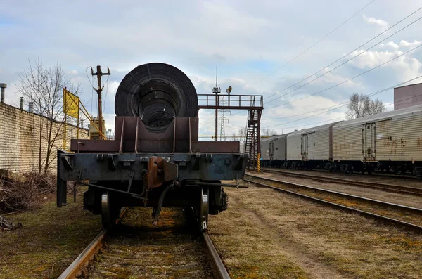 Cold rolled rolled steel in a package on a railway platform, cargo ready to be shipped to the customer