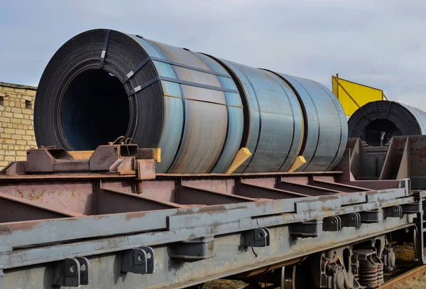 Steel sheets rolled up into rolls. Packing of steel for transportation freight train