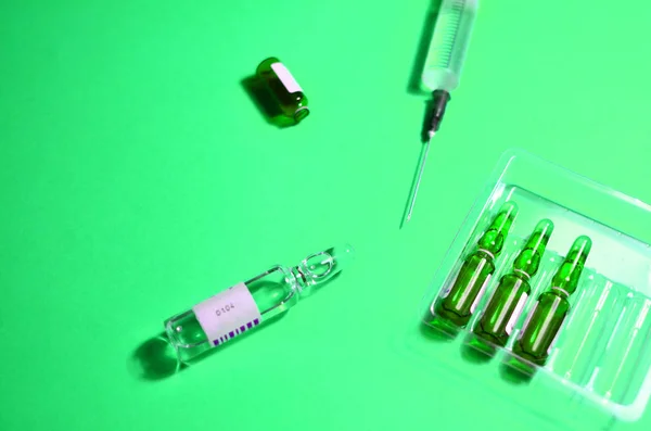 Medical syringe with a needle with injection.  The concept of emergency care for patients with acute pain. Anesthesia with essential and essential medicines, background, textures - Image