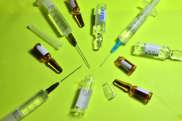 Medical syringes with a needle with injection.  The concept of emergency care for patients with acute pain. Anesthesia with essential and essential medicines, background, textures - Image