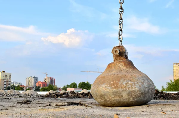 Large crawler crane or dragline excavator with a heavy metal wrecking ball on a steel cable. Wrecking balls at construction sites. Dismantling and demolition of buildings and structures - Image