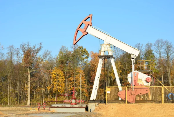 Oil drilling derricks at desert oilfield for fossil fuels output and crude oil production from the ground. Oil drill rig and pump jack.