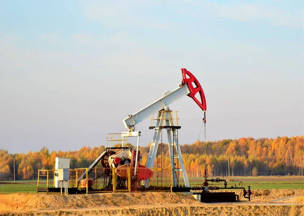 Oil drilling derricks at desert oilfield for fossil fuels output and crude oil production from the ground. Oil drill rig and pump jack.