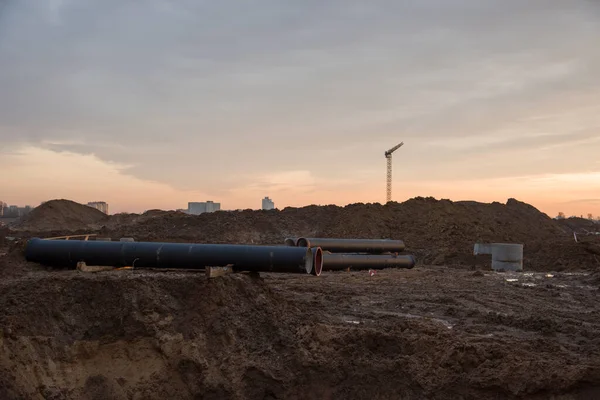 Laying or replacement of underground storm sewer pipes. Installation of water main, sanitary sewer, storm drain systems. Ground water drainage system pipes. Utility Infrastructure. Concrete pipe