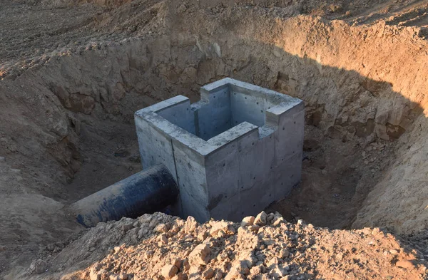 Construction of stormwater pits, sanitary sewer system distribution chamber and pump station. Sewerage manhole and pipes line under construction at the construction site. Sewage treatment works