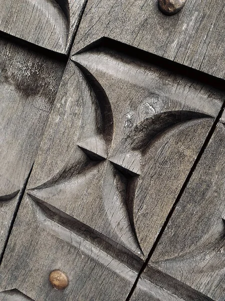 ornament on the door. Wood carving. Gray tree. Church, Minsk, Belarus