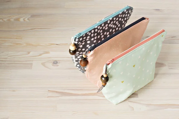 Cotton girl's makeup bags on the wooden table