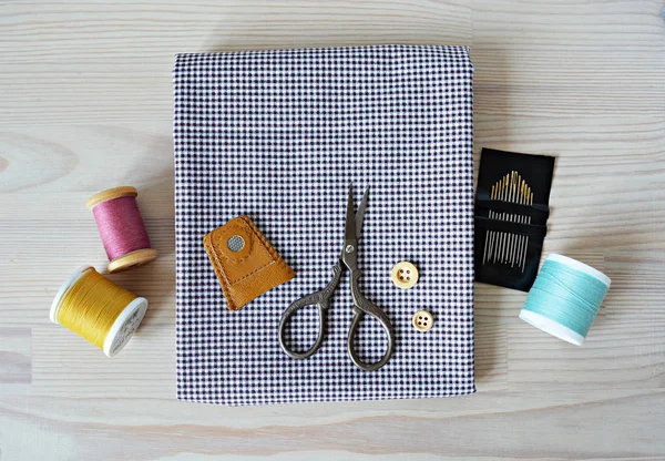 Hexagon english paper piecing templates, white cup, thread, retro scissors  and metal pins on the wooden table Stock Photo