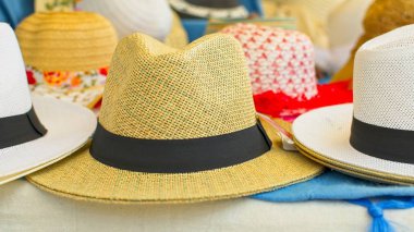 Güneşli bir sabah bir sokak pazarında geleneksel hasır şapkalar