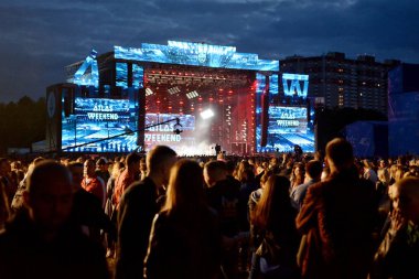 KYIV, UKRAINE - JULY 3, 2018: Stage and people during  at the Atlas Weekend Festival in National Expocenter clipart