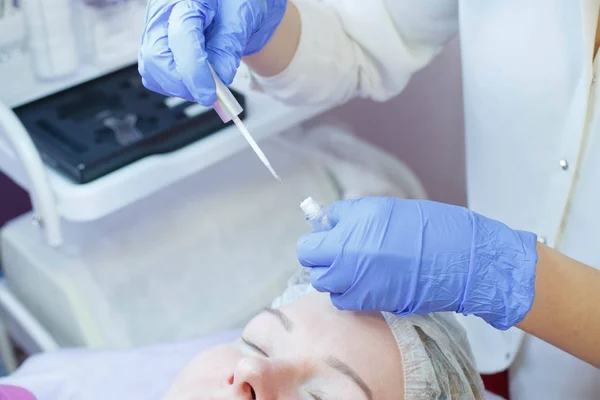 Woman on the procedure for eyelash extensions, eyelashes lamination