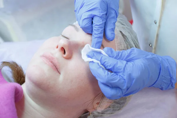 Woman on the procedure for eyelash extensions, eyelashes lamination