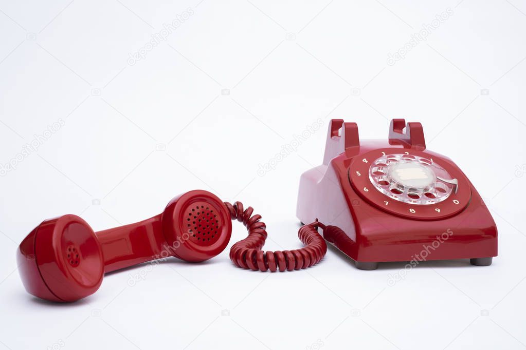 Retro landline red phone on a isolated white background
