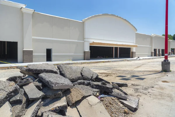 New Strip Shopping Center Construction Large Pile Torn Pavement Foreground — Stock Photo, Image