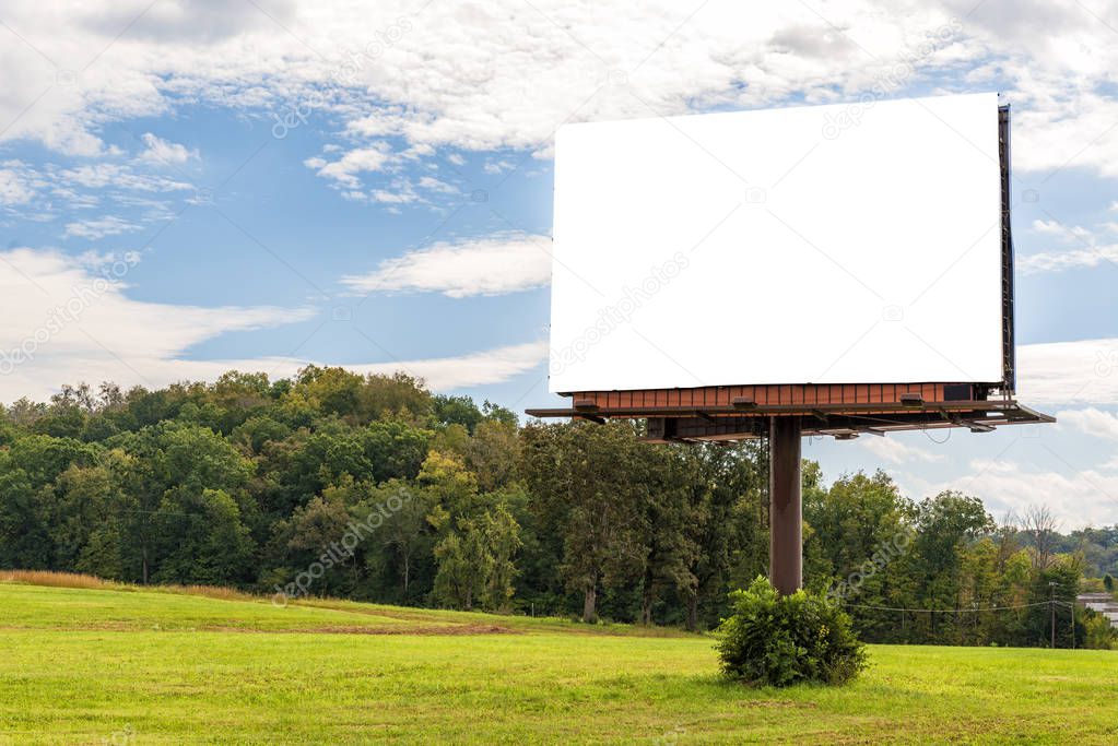 Horizontal shot of a Giant Blank Billboard mounted on a pole in an Autumn Setting With Copy Space.