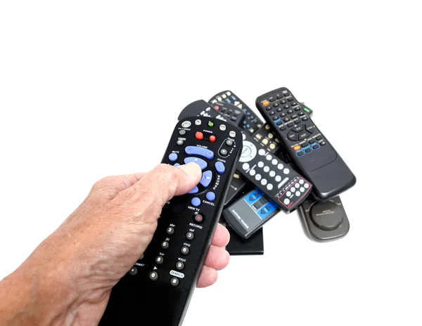 Hand Holding Remote Control With Stack in Background — Stock Photo, Image