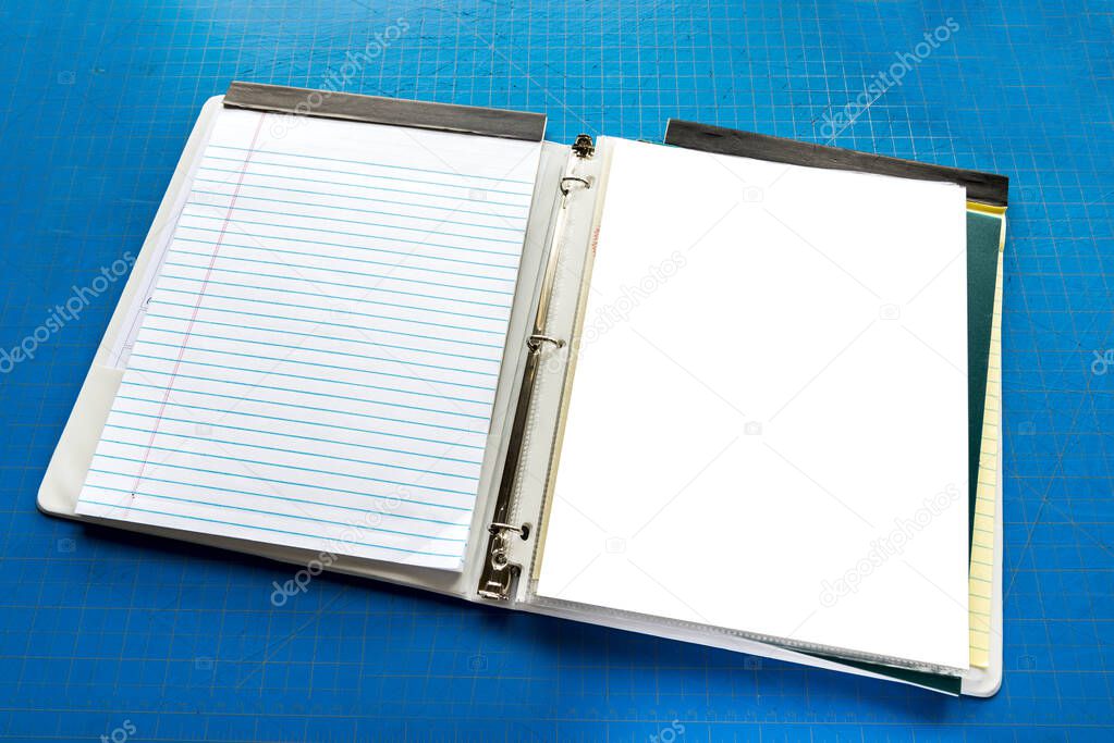 Open Notebook With Copy Space Against Blue Cutting Board Backgro