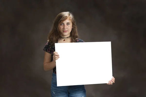 Χαριτωμένο κορίτσι προ-έφηβος με φακίδες κρατώντας κενό σημάδι — Φωτογραφία Αρχείου