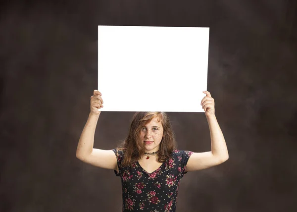 Serious Looking Pre-Teen Girl With Freckles Holding Blank White — Stock Photo, Image