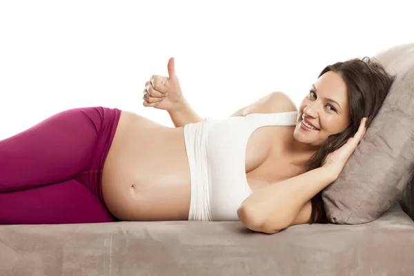 Happy Beautiful Pregnant Woman Lying Bed White Background Showing Thumb — Stock Photo, Image