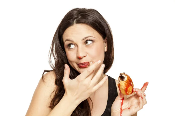 Sehnsuchtsvolle Junge Frau Isst Einen Kirschkernkrapfen Auf Weißem Hintergrund — Stockfoto