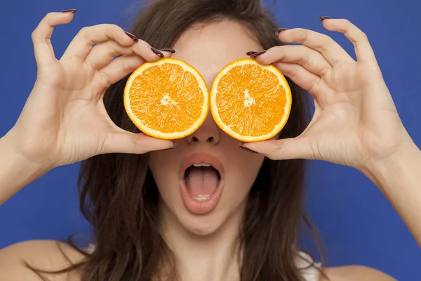 Surprised Young Woman Posing Slices Orange Her Face Blue Background — Stock Photo, Image