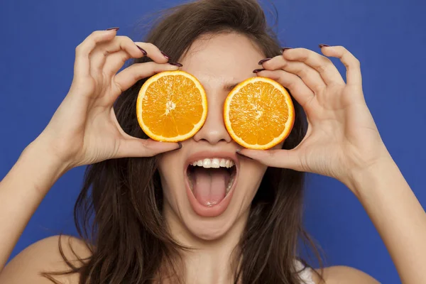 Happy Young Woman Posing Slices Orange Her Face Blue Background — Stock Photo, Image