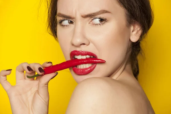 Young Sexy Woman Biting Chili Pepper Yellow Background — Stock Photo, Image