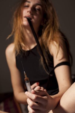 Uyuşturucu kullanan bir şırınga uyuşturucu bağımlısı kız