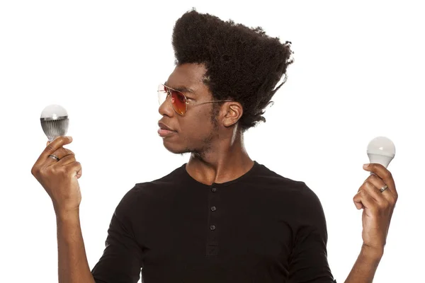 Young Handsome Afro American Guy Holding Led Bulbs Isolated White — Stock Photo, Image