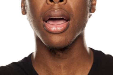 Genç bir Afrikalı-Amerikalı siyahi bir açık ağız bakış beyaz bir arka plan üzerinde kapatın