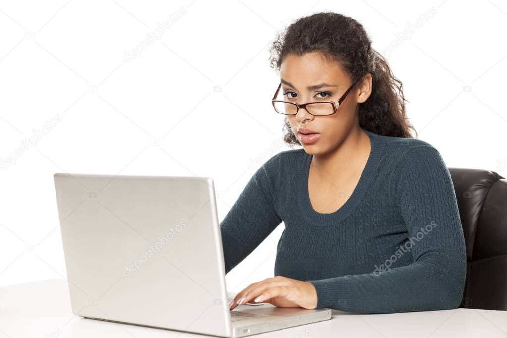 Hard day in the office. Shot of a young african businesswoman looking stressed while sitting in her office in front of laptop