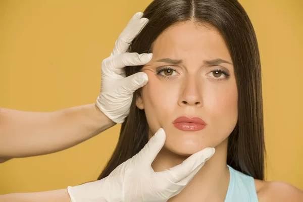 Doctor Hands Checking Wrincles Young Woman Yellow Background — Stock Photo, Image