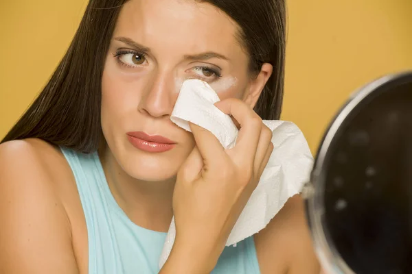 Young Woman Cleaning Her Face Wet Wipes Yellow Background — Stock Photo, Image