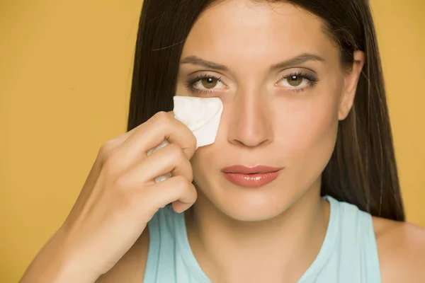 Young Woman Cleaning Her Face Wet Wipes Yellow Background — Stock Photo, Image
