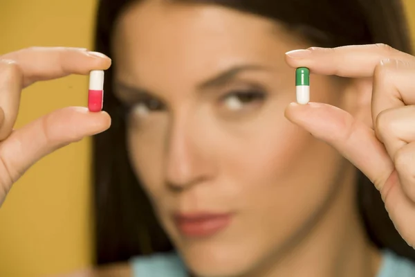 Closeup Woman Holding Capsules Her Fingers — Stock Photo, Image