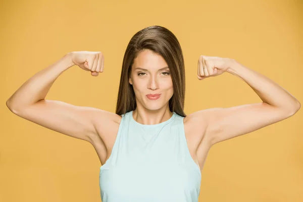 Young Smiling Woman Showing Her Hands Yellow Background — Stock Photo, Image