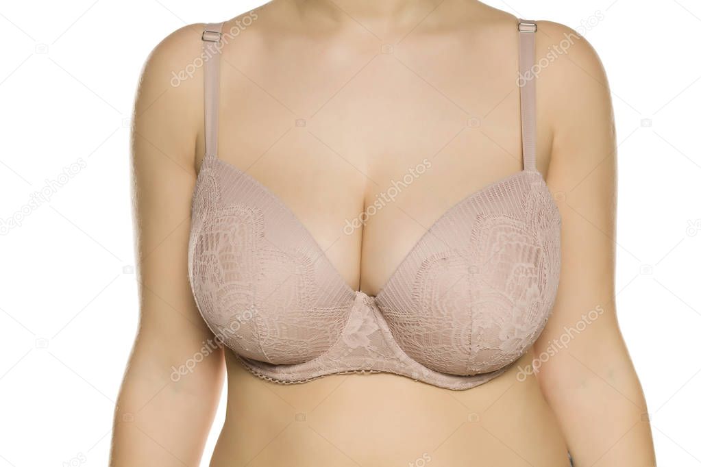 Beautiful big breasts in bra on white background