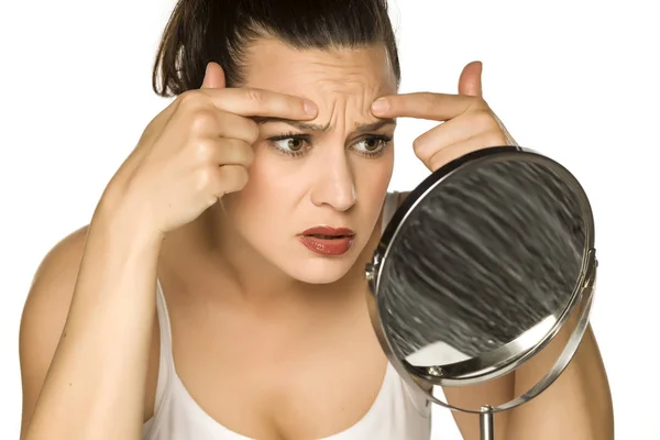 Young Woman Pinching Her Forehead Wrinkles Her Fingers White Background — Stock Photo, Image