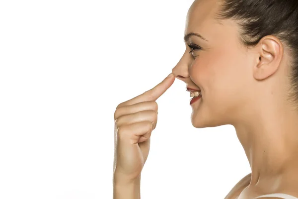 Young Happy Woman Touches Her Nose Her Finger White Background — Stock Photo, Image