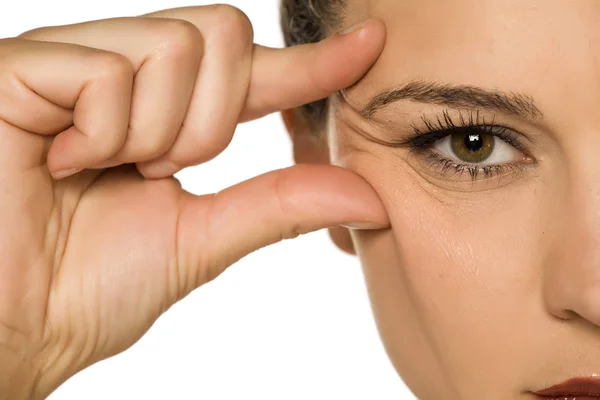Young Woman Pinching Her Eye Wrinkles Her Fingers White Background — Stock Photo, Image