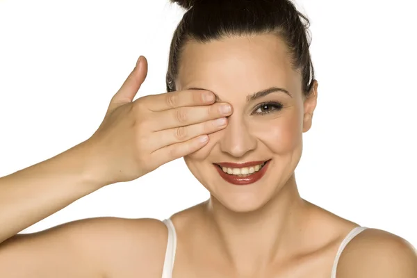 Young Smiling Woman Covering Her Eyewith Her Hand White Background — Stock Photo, Image