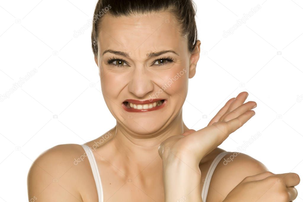 young disgusted woman on white background