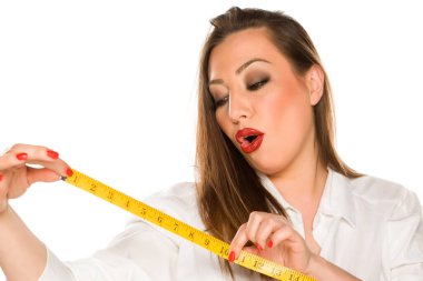 Güzel, mutlu, uzun saçlı bir kadının portresi. Beyaz arka planda şerit tutuyor.