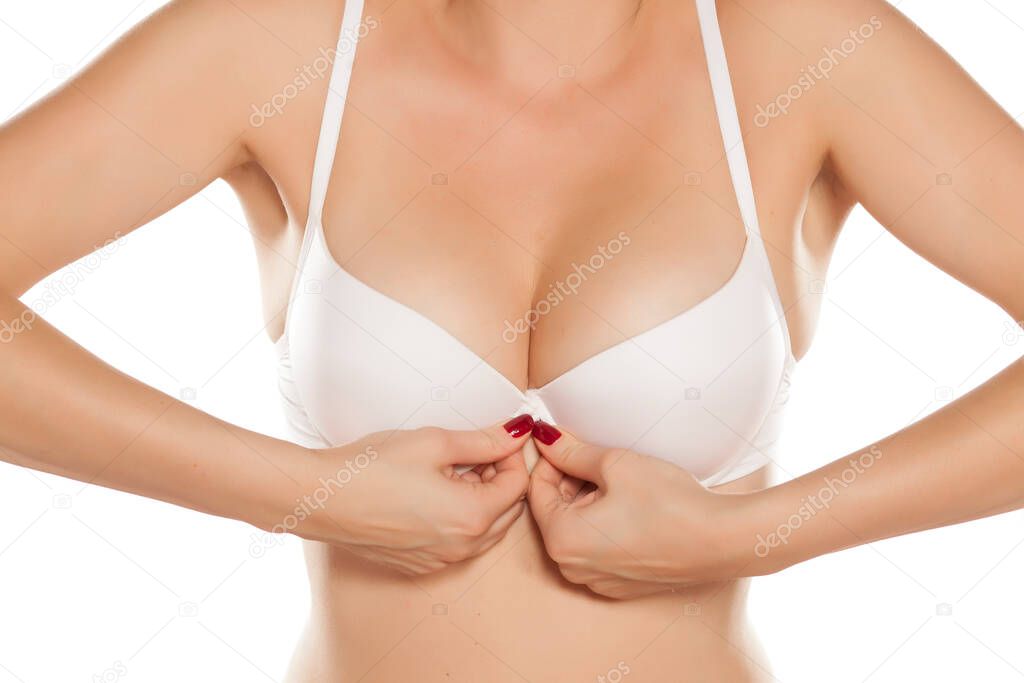 woman buttoned her white bra