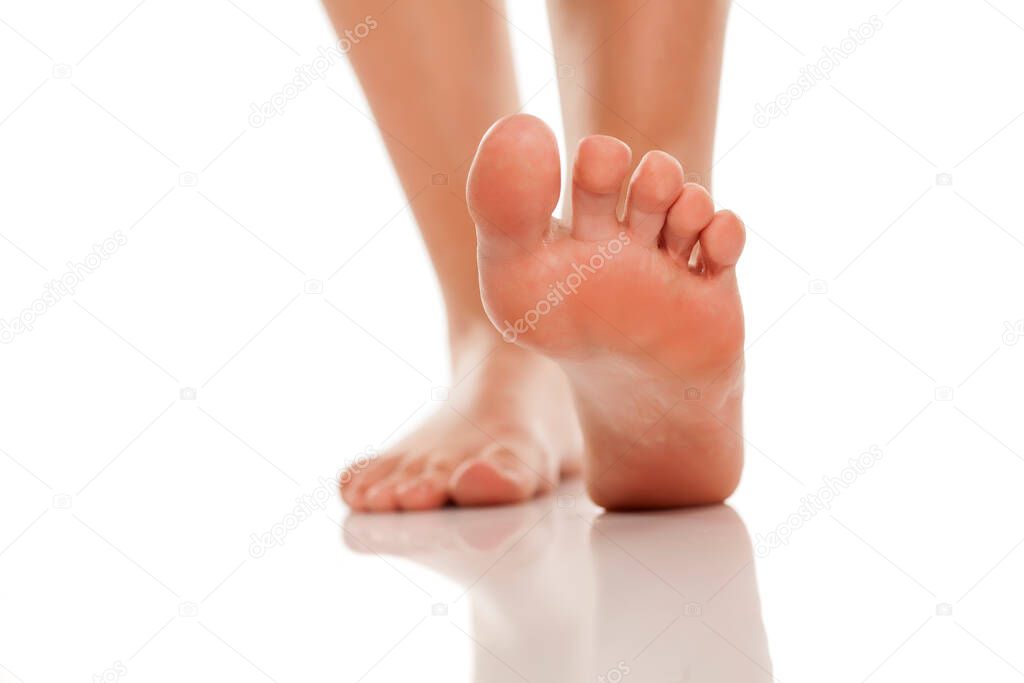 beautifully groomed bare feet on white background